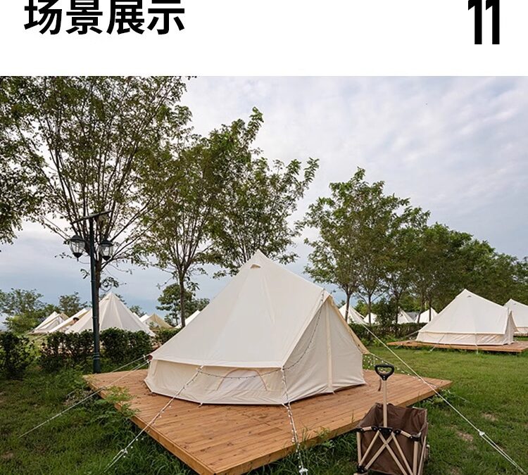 Bell tents on wooden platforms in a grassy area with trees stretch under a partly cloudy sky. A wheeled cart rests in the foreground, adding rustic charm.