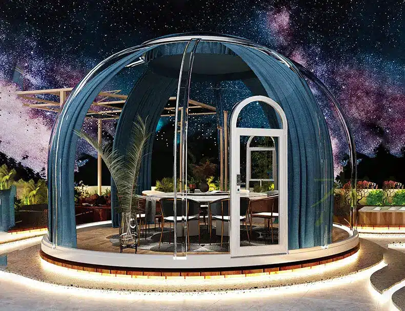 A modern, dome-shaped outdoor seating area with blue curtains and a clear roof, set against a night sky with stars and a purple galaxy background.