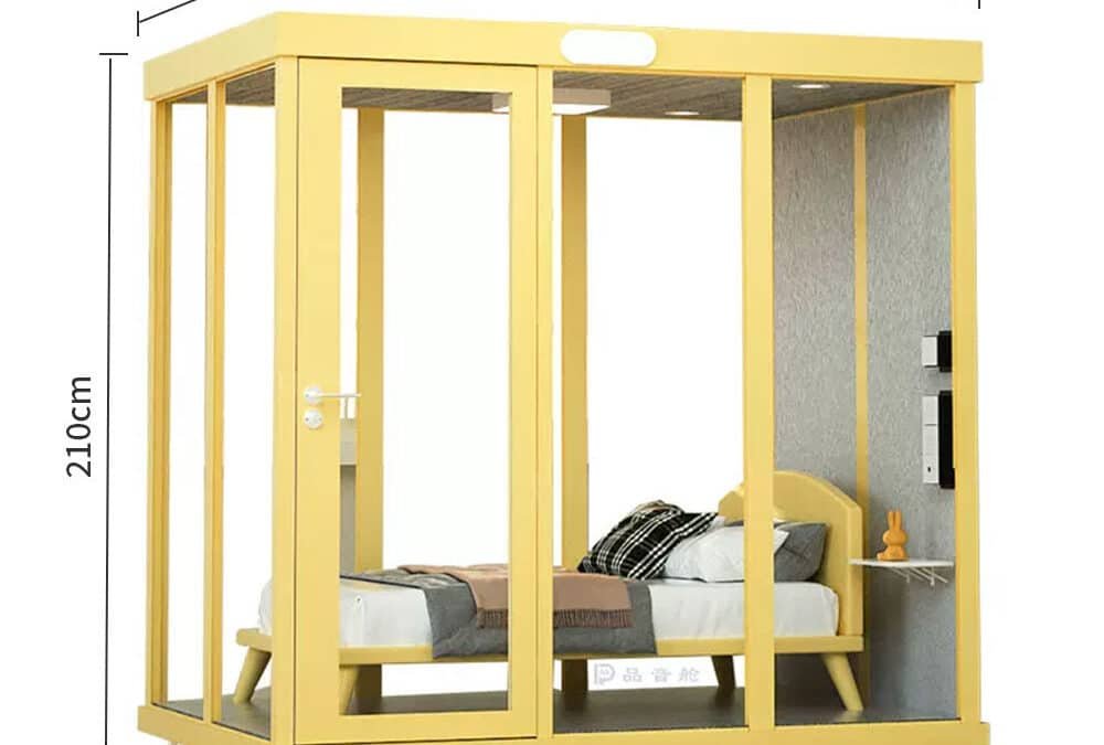 A yellow soundproof sleeping pod with glass walls and door, containing a single bed and a small shelf; dimensions labeled as 210cm x 210cm x 150cm.